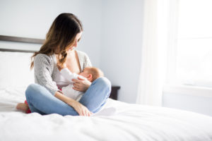 Mother holding her baby breastfeeding.